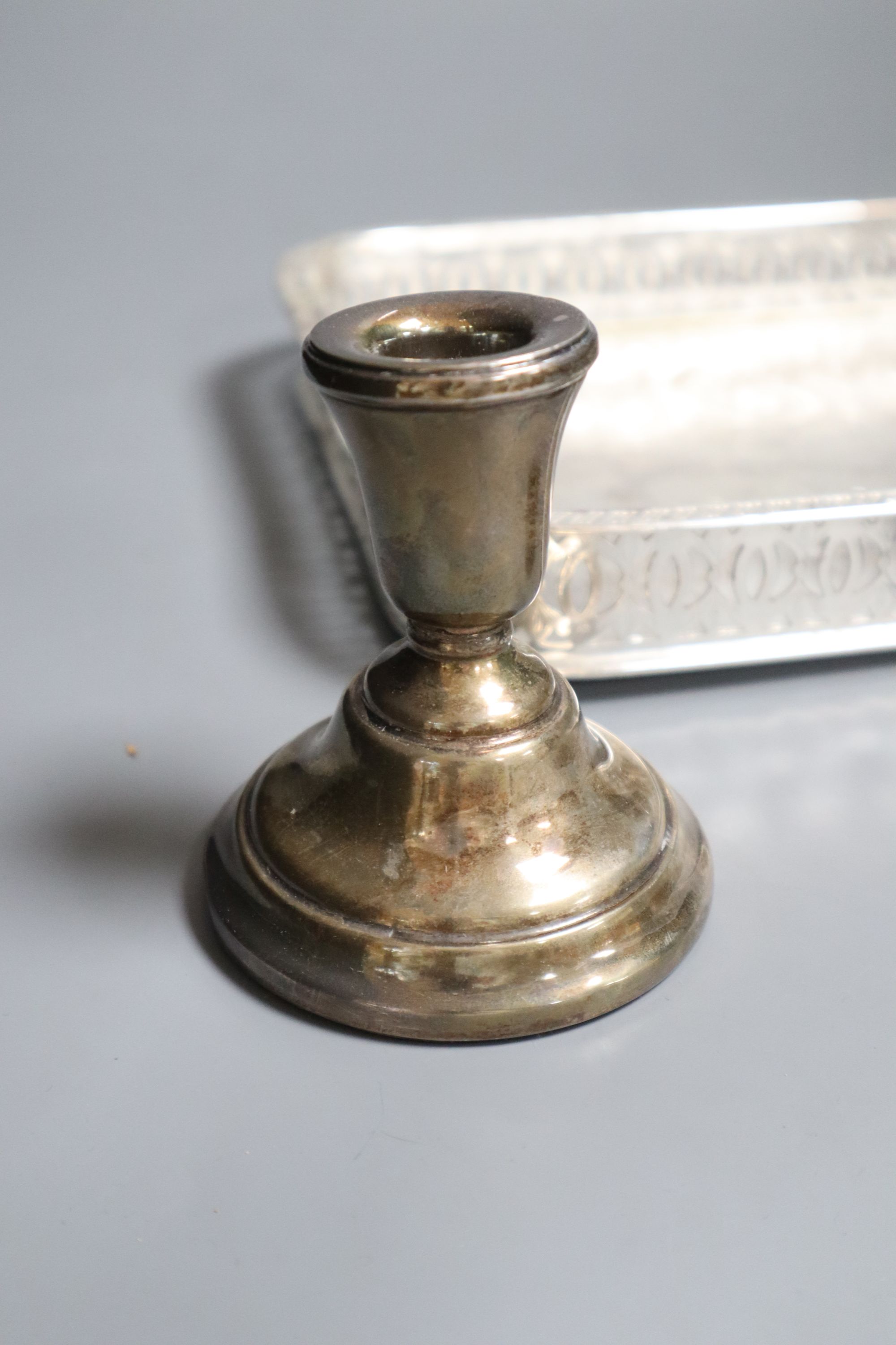 A plated tray, a pair of silver dwarf candlesticks and two napkin rings